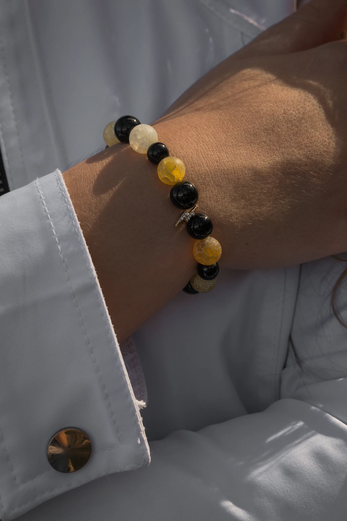 Beaded bracelet worn with a pale blue shirt