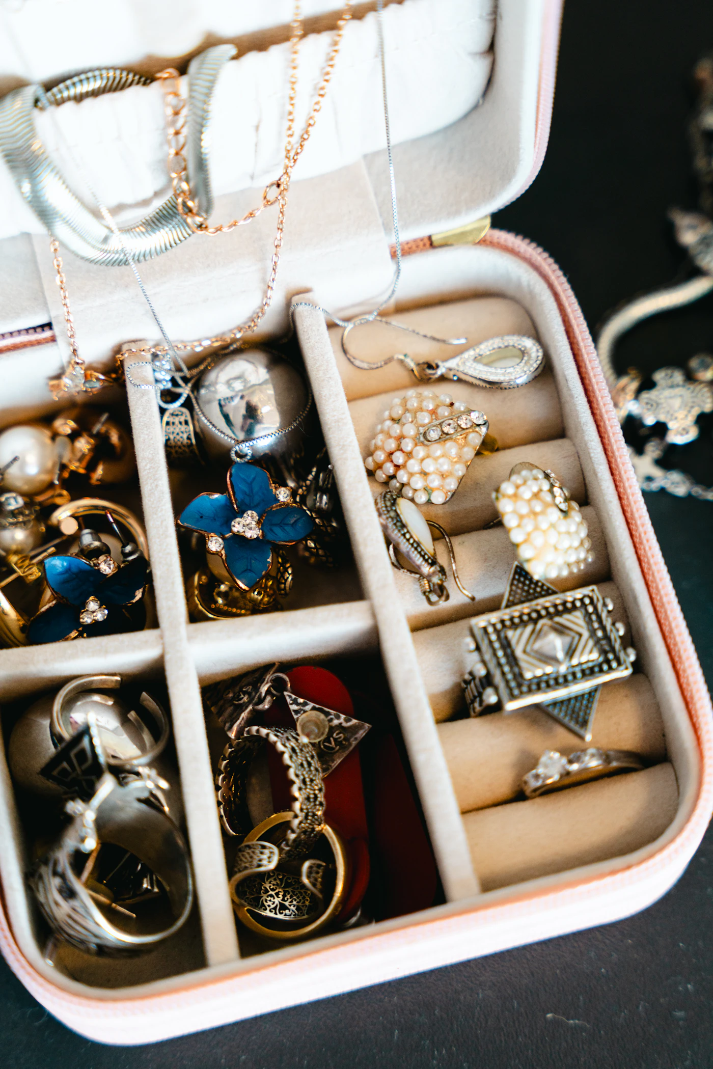 Open jewellery case filled with necklaces rings and earrings