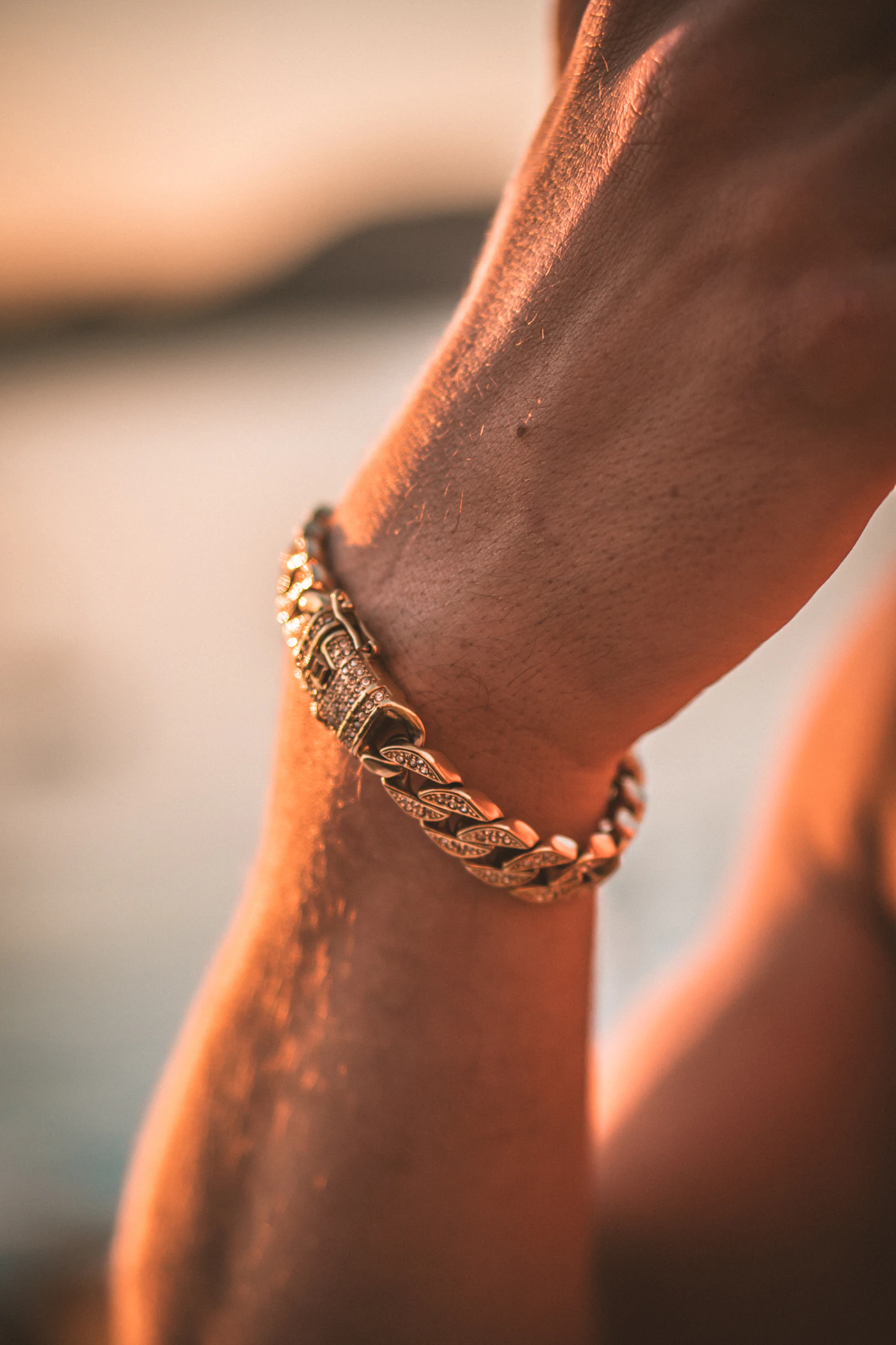 Chain bracelet on a wrist in warm evening light