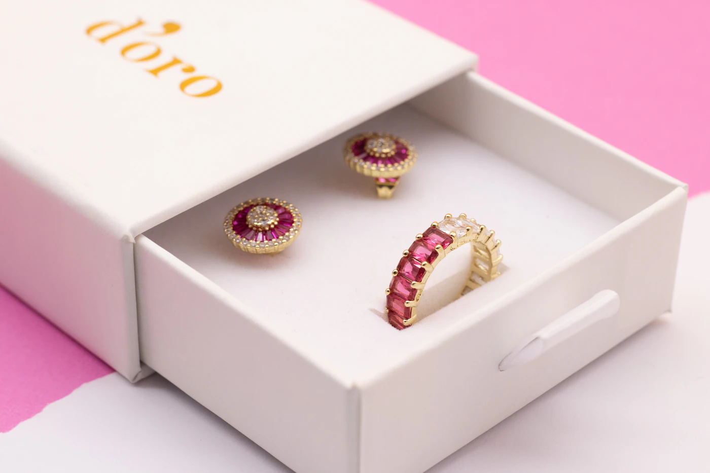 Pink jewellery gift box containing earrings and a ring