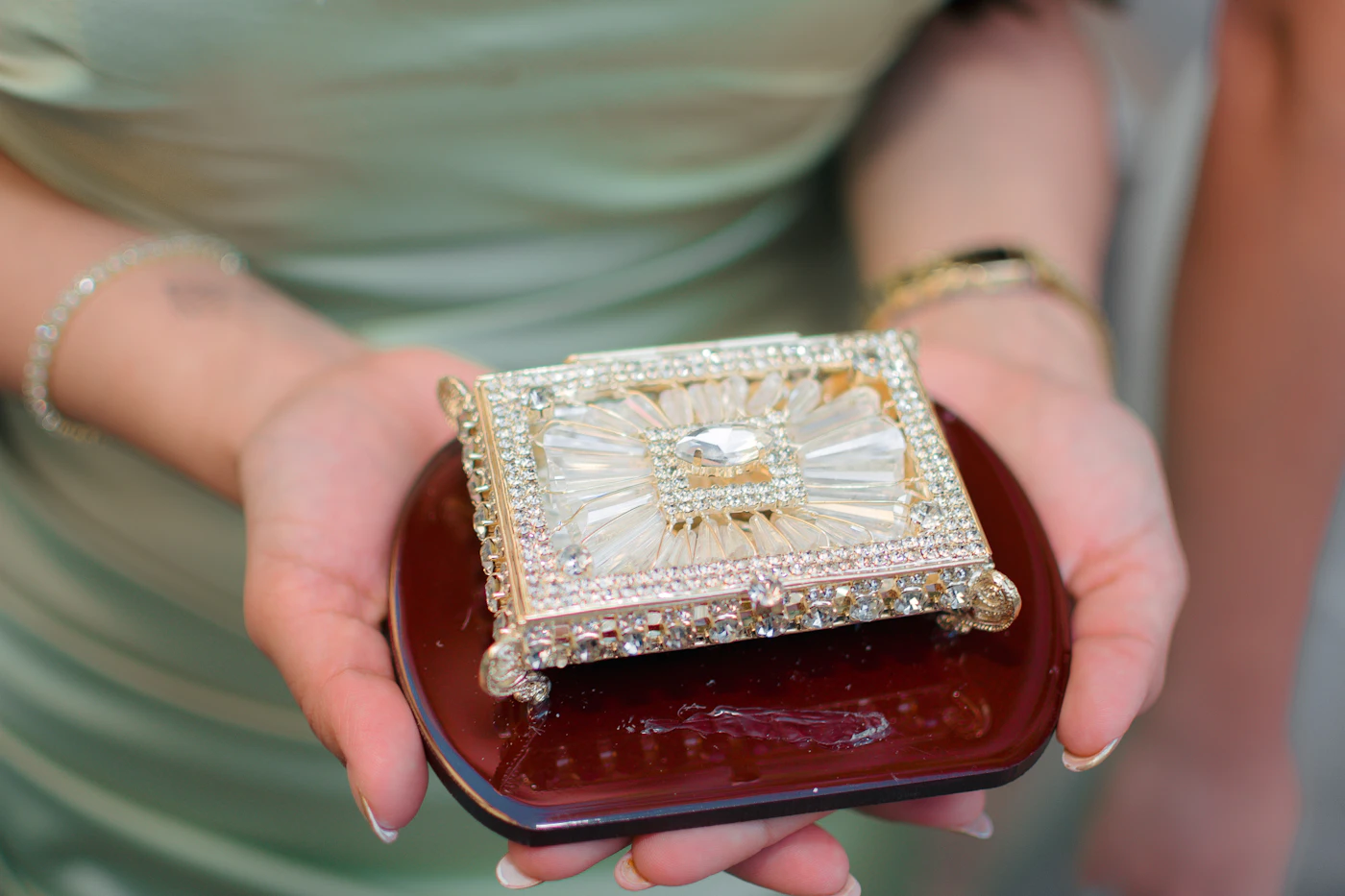 Hands holding a decorative jewellery keepsake box