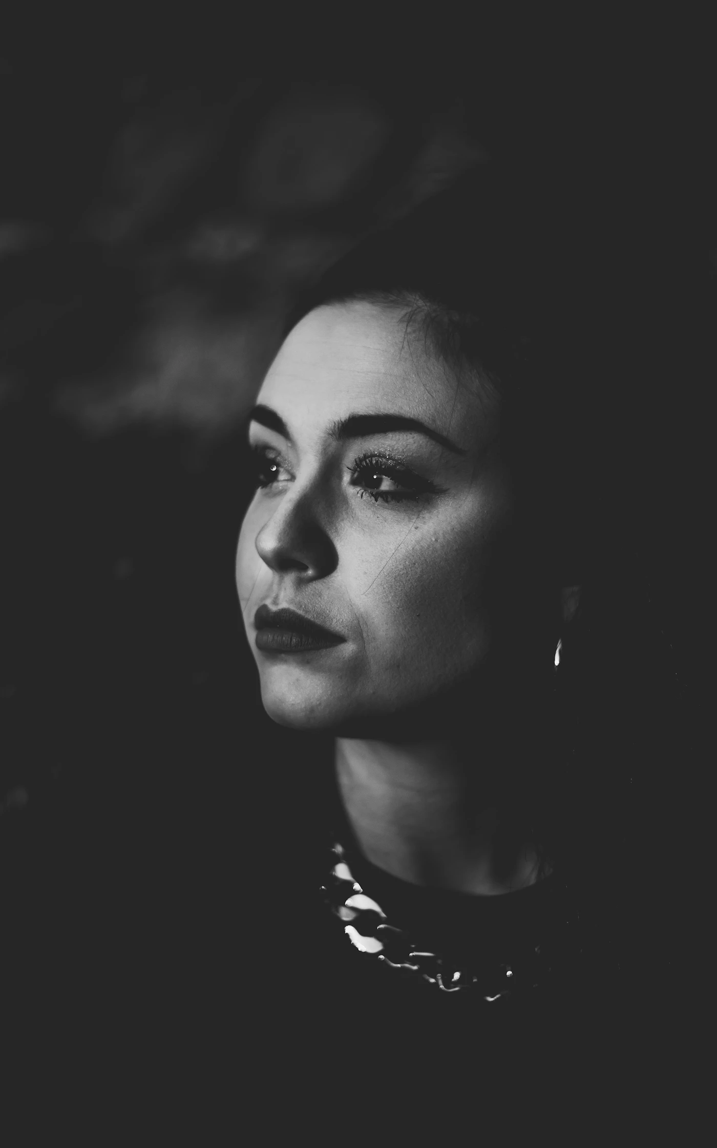 Black-and-white portrait of a woman wearing a necklace