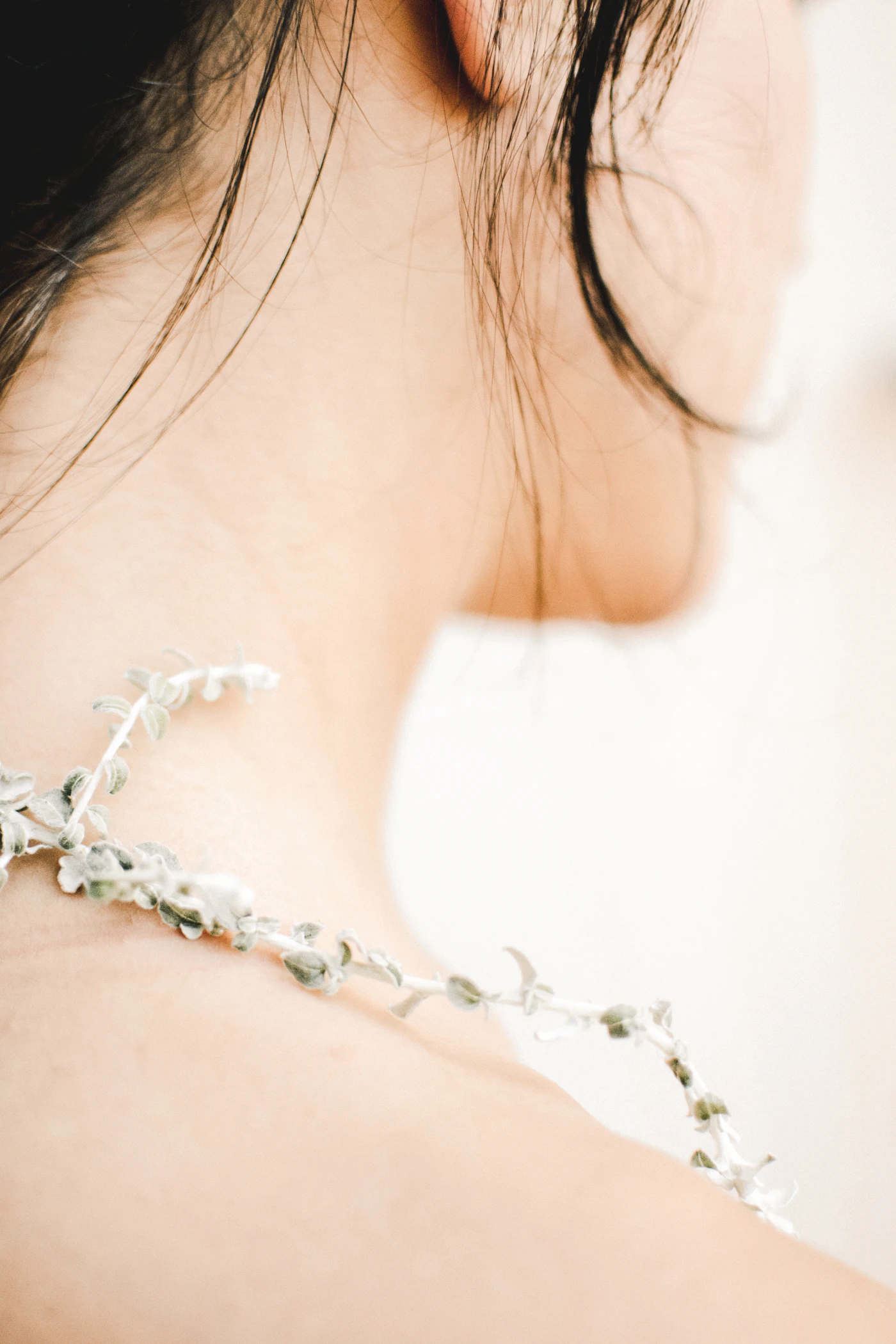 Necklace resting across a woman’s shoulder