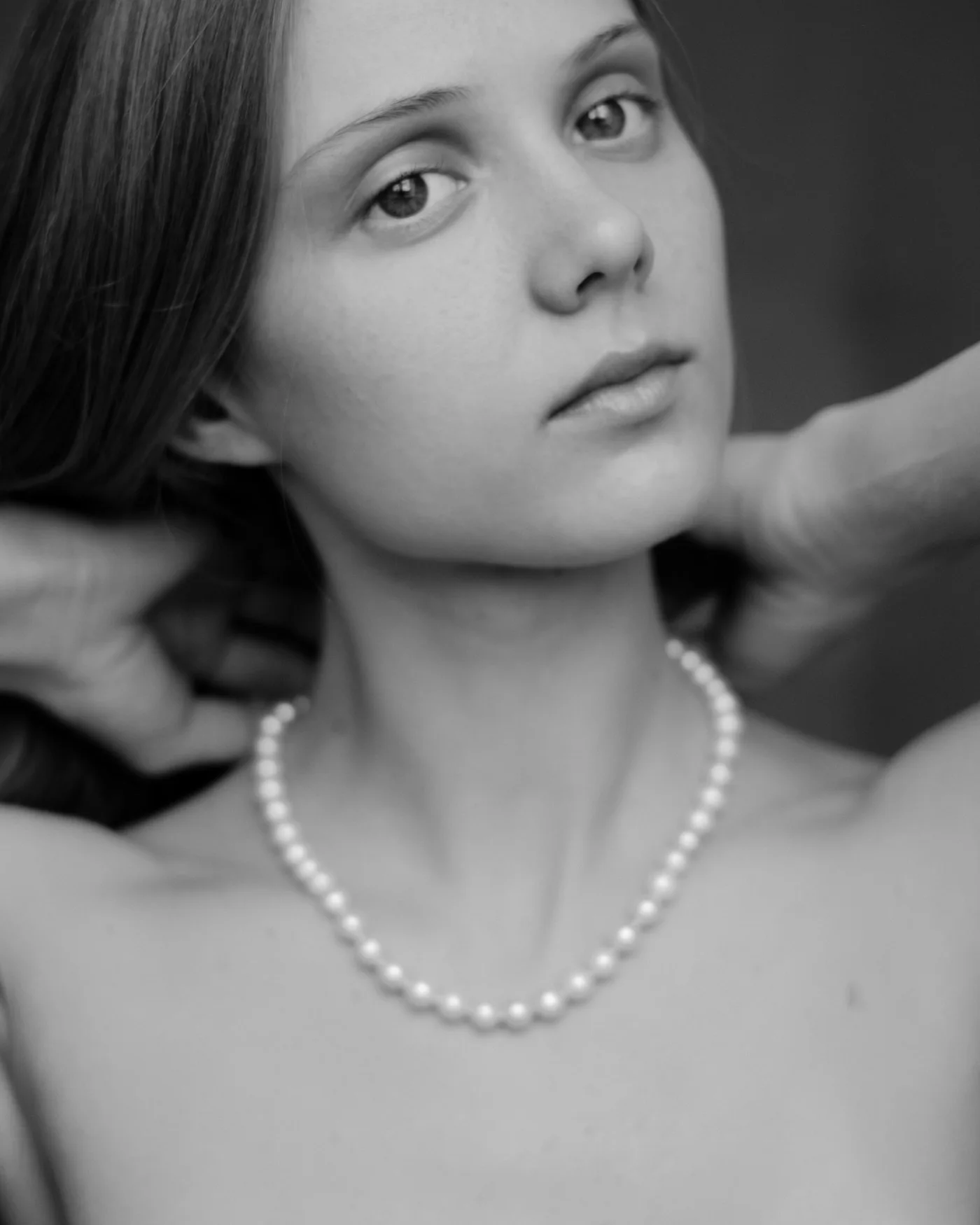 Young woman wearing a pearl necklace in a portrait