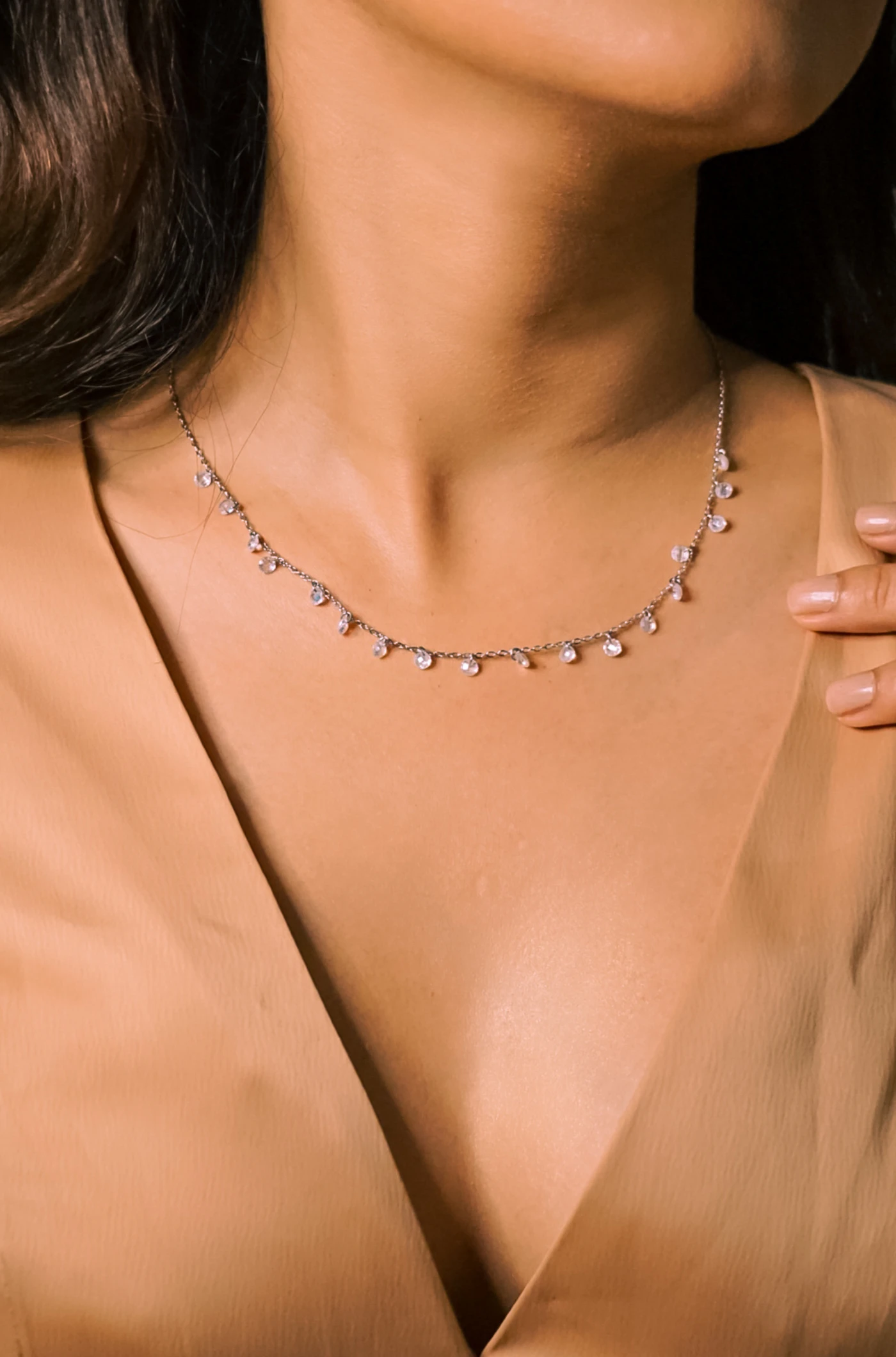 Fine necklace worn with a black evening top